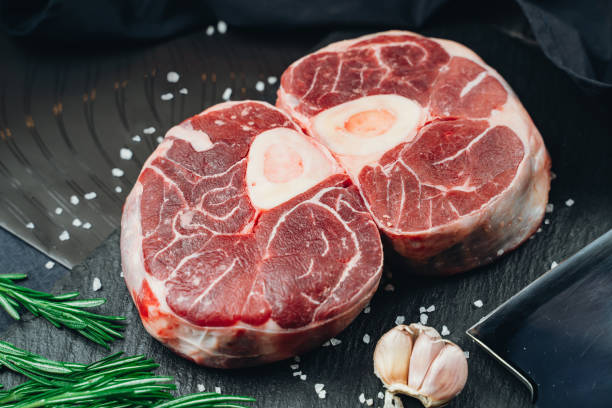 istock Raw beef steak on a dark background. Top view. 1395380335