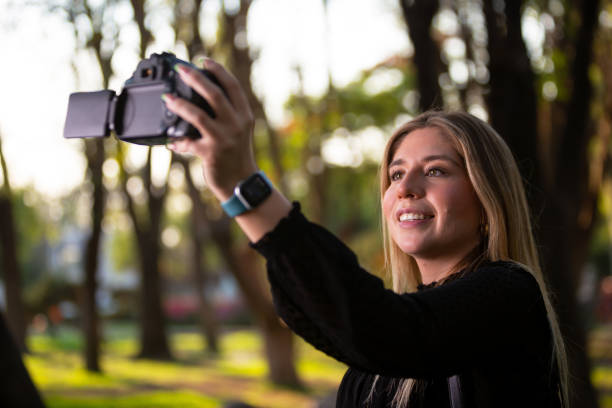 istock Executive woman taking a selfie with her DSLR. 1395384879
