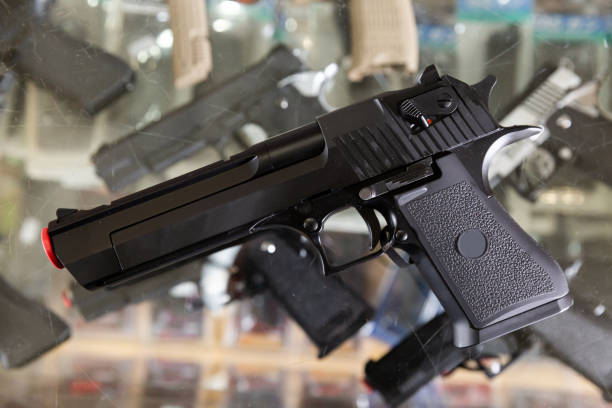 istock Pneumatic weapon on glass table in army store 1395386457