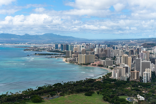 Cityscape of Hawaii with blue Pacific Ocean, beach, and waves