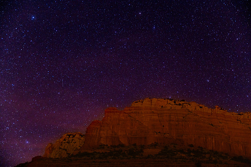 Night sky with stars over red desert mesa