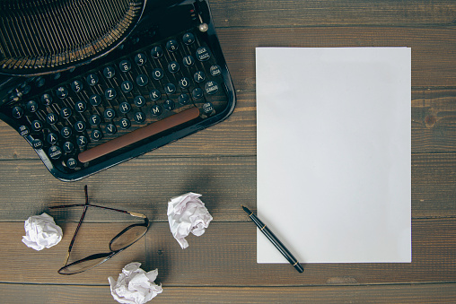 Old typewriter, crumpled paper and coffee.