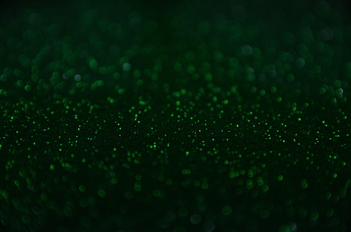 Festive background. Green background with bokeh. Blurred background. Abstraction circles.