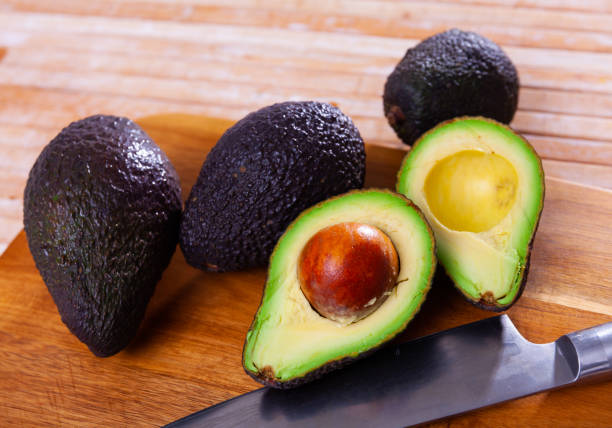 istock Raw organic avocado on wooden table 1395389636