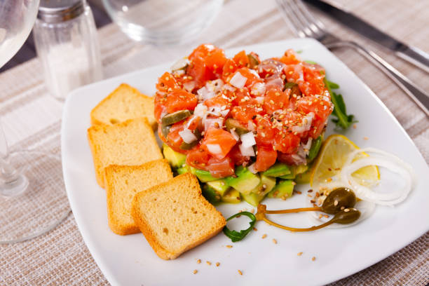 istock Salmon tartare with avocado and toasted bread 1395389657