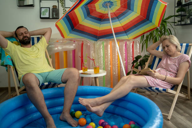 istock Happy couple who cannot go on holiday has fun at home 1395391186