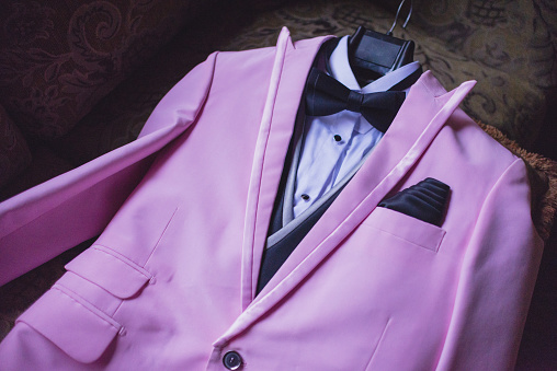 pink groom suit at a wedding