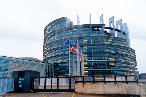 Strasbourg, France - Decembre, 2021: European Parliament. Waving all EU flags in front of the European Parliament.