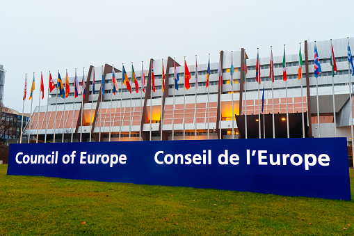 STRASBOURG, FRANCE - January, 2022: Council of Europe Court in Strasbourg. Eu flags flies.