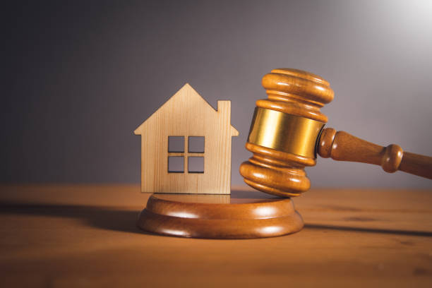 istock Wooden judge hammer and house model 1395398983