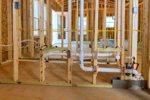 interior of brick house under construction with water inlet and evacuation tubes