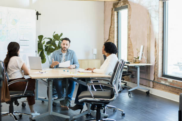 istock Corporate trainer meets with the team 1395400671