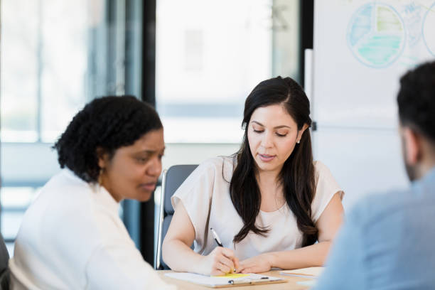 istock Coworker helps with meeting minutes 1395400697