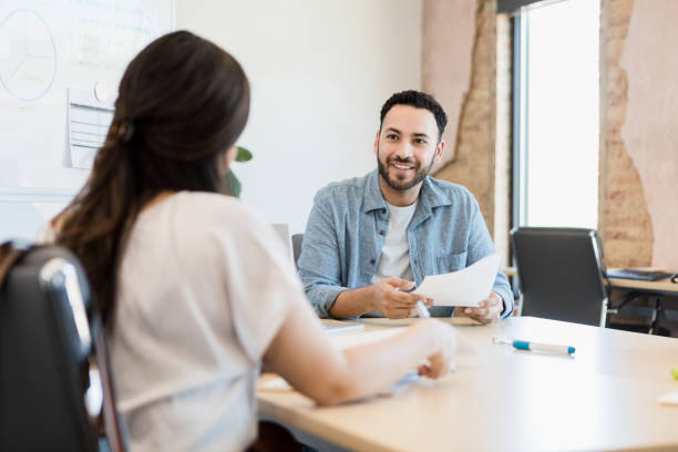 istock Male business owner interviews unrecognizable woman 1395401453