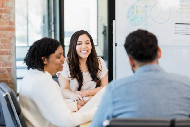 istock Three diverse people meet to discuss business 1395401473