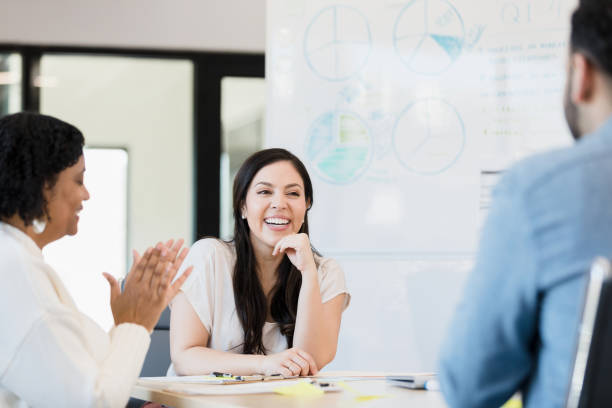 istock Businesswomen encourage unrecognizable male co-worker 1395401478
