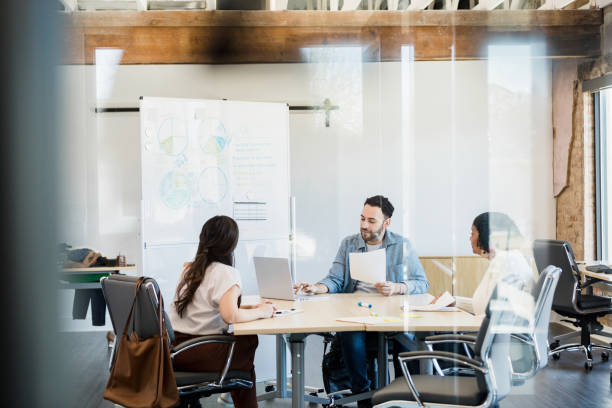 istock Diverse co-workers meet in conference room 1395401491