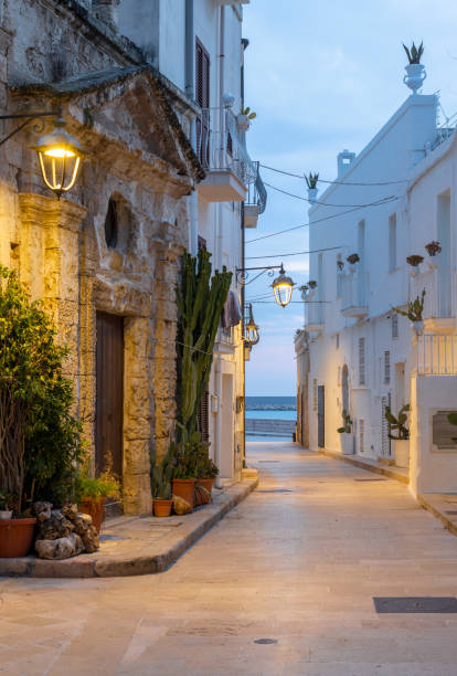 Monopoli - The old town aisle with the little chapel at dusk. Monopoli - The old town aisle with the little chapel at dusk. monopoli puglia stock pictures, royalty-free photos & images