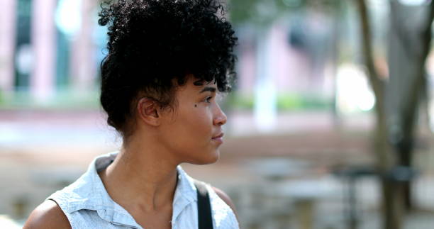 istock Black woman standing outside observing environment 1395402853