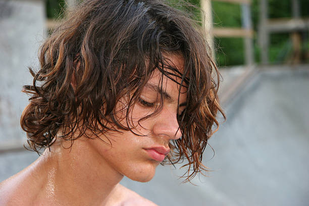 Close-up of male teen tired and sweaty after hours of skateboarding. Shot with Canon 20D.