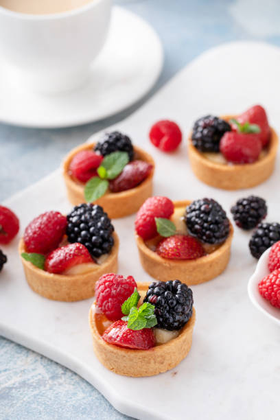 istock Fresh berries tartlets with custard filling and mint 1395404256