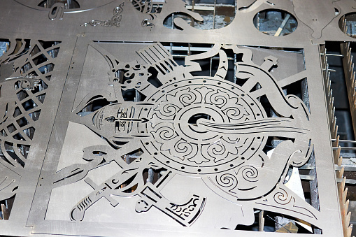 steel artwork cutted on cnc laser cutting machine in workshop