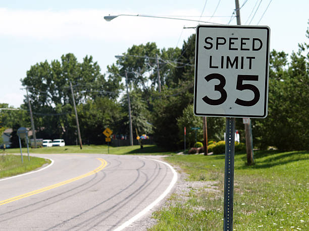 Slow Down... 35 MPH Speed Limit Sign in a small town speed limit sign stock pictures, royalty-free photos & images