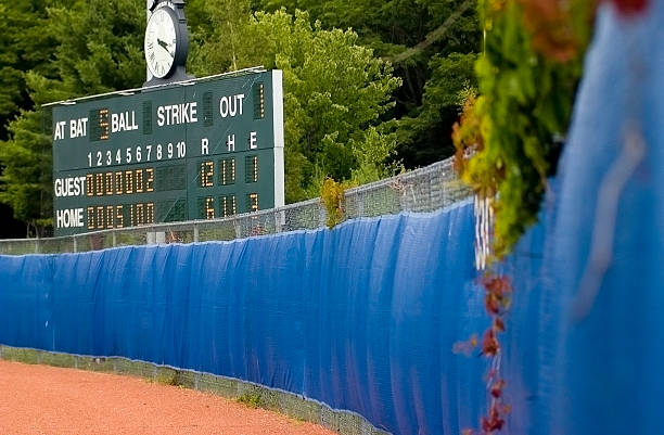 Score Down the fence view of a baseball scoreboard in Maine outfield stock pictures, royalty-free photos & images