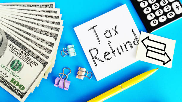 Tax Refund is shown using the text and photo of dollars Tax Refund is shown using a text and photo of dollars refund stock pictures, royalty-free photos & images