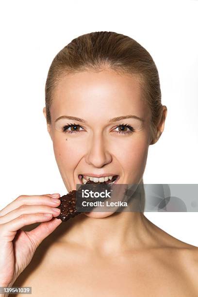 Foto de Retrato De Uma Menina Comendo Chocolate e mais fotos de stock de Adulto - Adulto, Beleza, Boca Humana