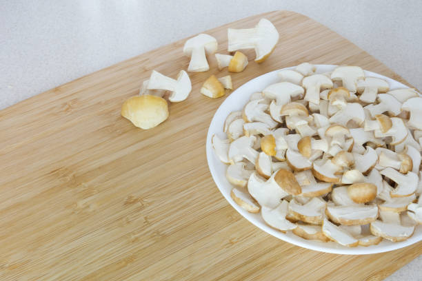 Spring mushrooms Calocybe gambosa lie in a round plate. Spring mushrooms Calocybe gambosa lie in a round plate. The mushrooms are washed and peeled. A place for your text. High quality photo Blewit stock pictures, royalty-free photos & images