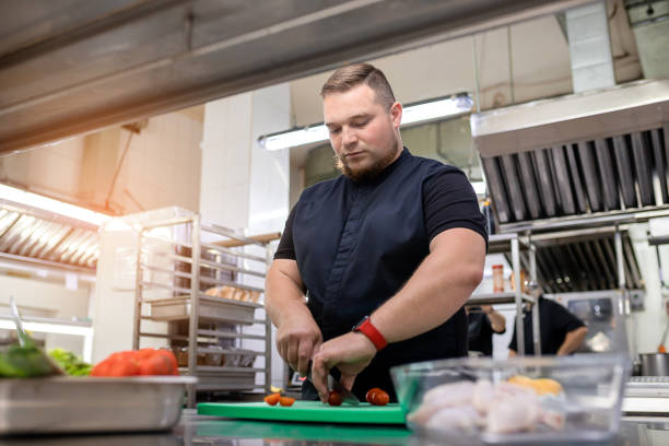 istock The chef in the kitchen cuts a tomato for the chicken dish 1395410736