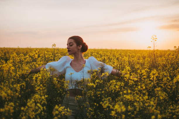 istock Young red-haired woman in a rapeseed field 1395411524