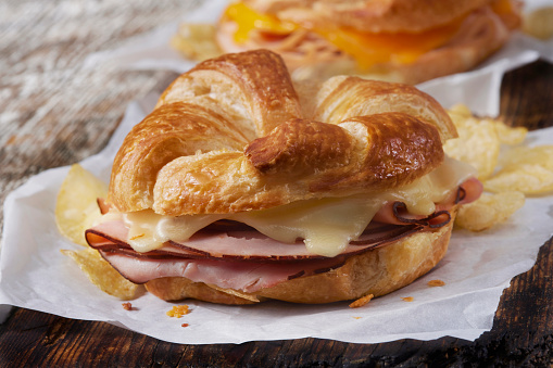 Baked Ham and Swiss Cheese Croissant Sandwich with Potato Chips