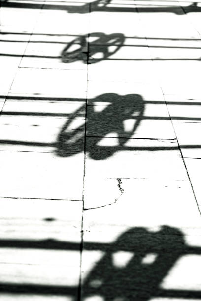 Black and white shadow on concrete footpath, abstract background with copy space, full frame vertical composition
