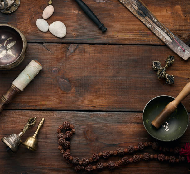istock Tibetan singing copper bowl with a wooden clapper , objects for meditation and alternative medicine, top view. Plunging into a trance 1395414702