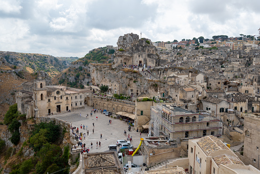 Matera, Basilicata, Italy. August 2021. Stunning view with the church of San Pietro Caveoso on the left and the rock church of Santa Maria di Idris further up on the right. Urban landscape of stones.