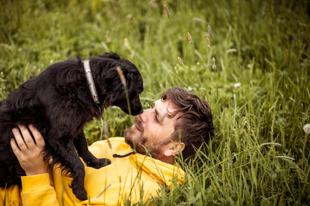 istock Young Man Having Fun With His Dog 1395415585