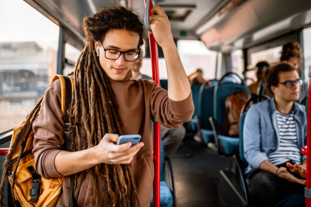 young man riding in bus on his way to job - bus riding public transportation businessman imagens e fotografias de stock