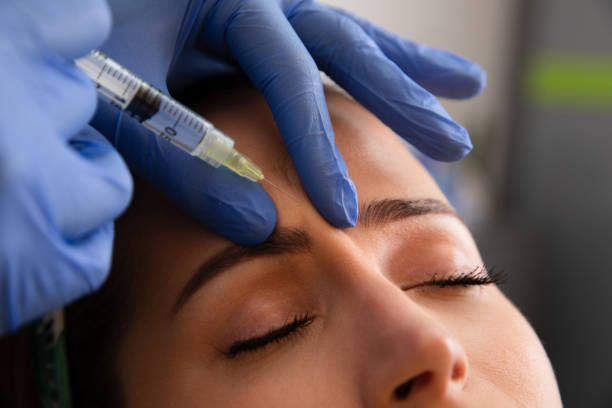 Botox Treatment Young woman receiving a botox injection medical injection stock pictures, royalty-free photos & images