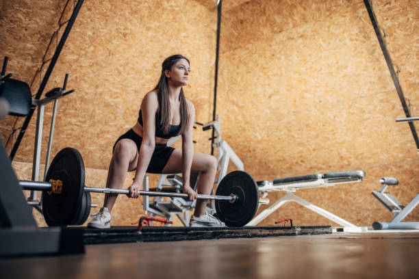 istock Young woman weightlifting 1395416477