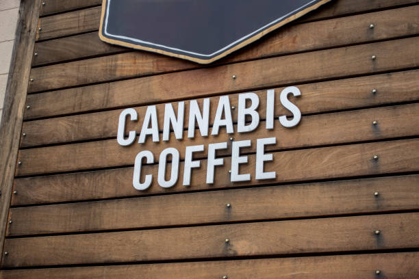 view of the words cannabis coffee on a wooden, rustic looking building exterior - photography sign table ganja imagens e fotografias de stock