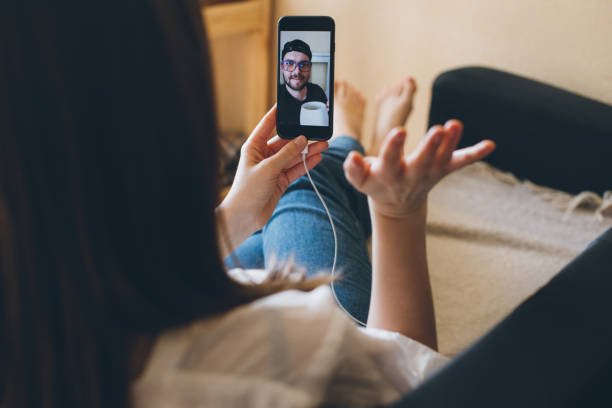 istock Young woman doing video chat with men at home. 1395417901