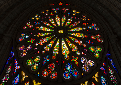 Close up detail of vaulted arches and stained glass in a medieval cathedral in Europe. High quality photo