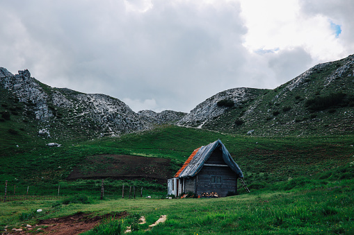 Old wooden lonely cottage in the mountains.