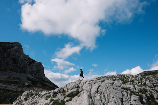 Young woman on a hiking trip through the mountains in Dinaric Alps, Southeastern Europe.