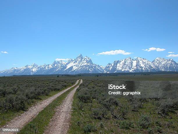 Grand Tetons With Rutted Road Stock Photo - Download Image Now - Agricultural Field, Blue, Extreme Terrain