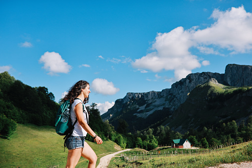 Young woman on a hiking trip through the mountains in Dinaric Alps, Southeastern Europe.