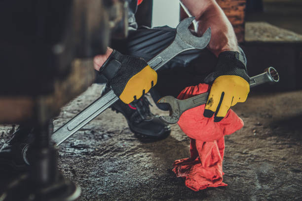 istock Heavy Equipment Mechanic with Large Iron Wrenches 1395421053