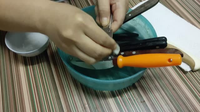 Cleaning Steel Kitchen Knife in A Water